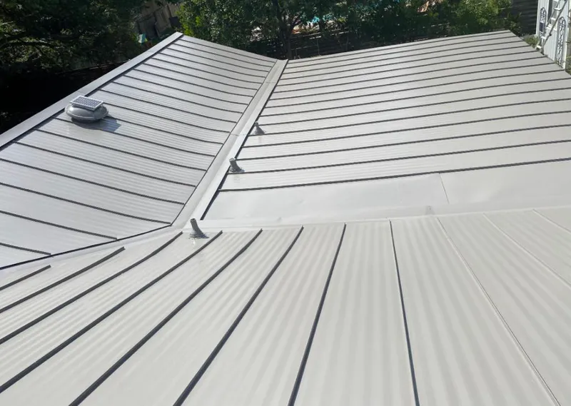 Solar attic fan installed on a metal roof for Roof Ventilation in Bartow